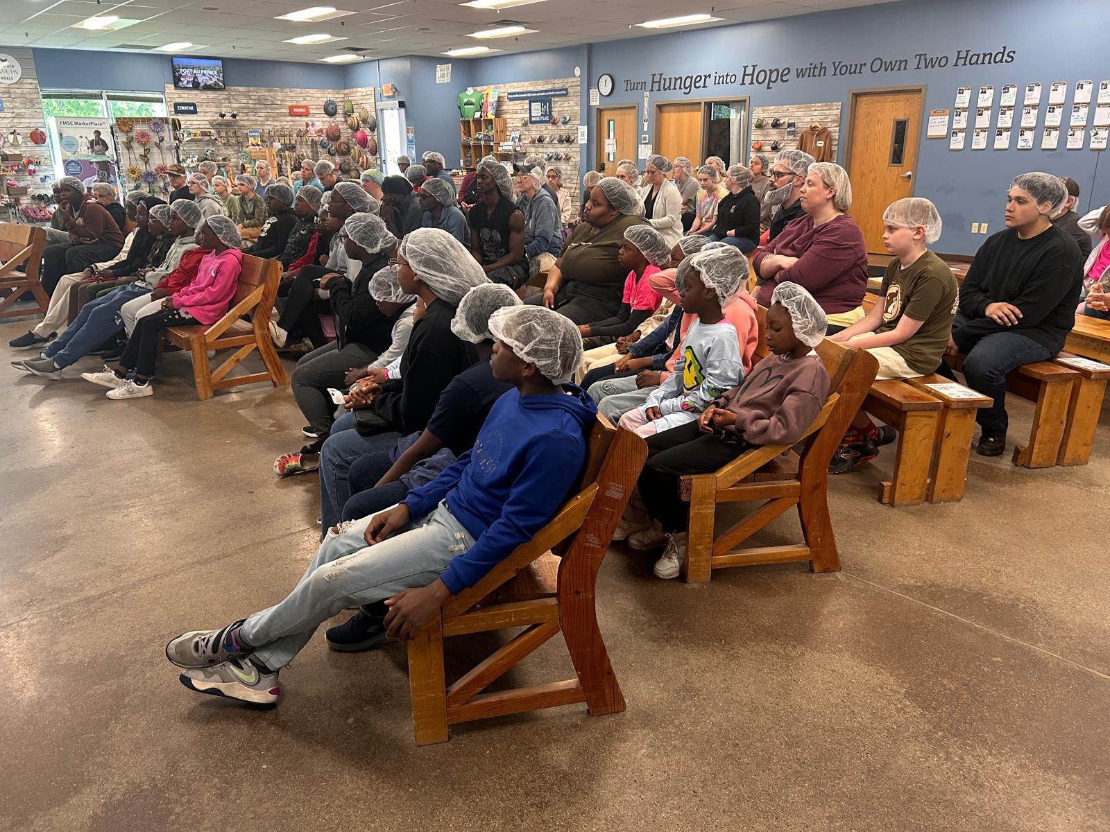 Church members volunteering at Feed My Starving Children event